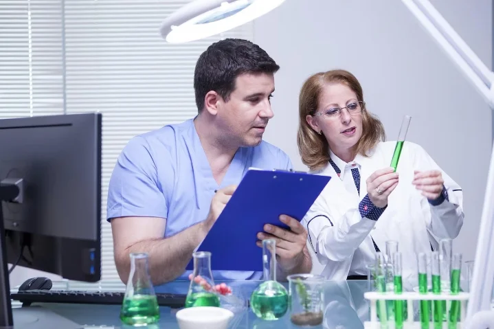 Healthcare professionals reviewing a sample in a clinical setting